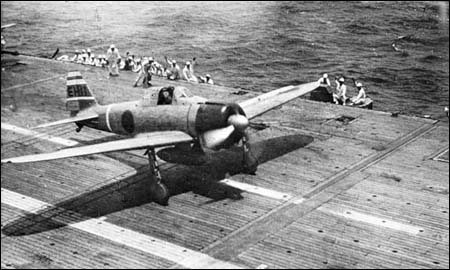 Leading a flight of Zeros during the Battle of Santa Cruz, Lt Hideki Shingo roars down the wooden deck of "Shokaku". The tail of Shingo s A6M2 carriers three White stripes on the tail which are outlined in Red and indicates that the plane belongs to a  flight leader. El-111 is also in Red.